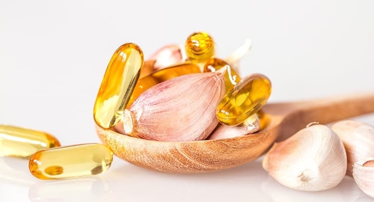 Fish oil pills and garlic bulbs