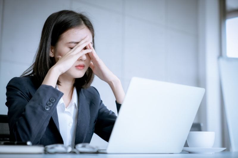 woman at desk stressed