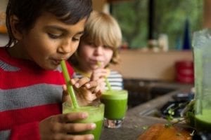 kids drinking green juice