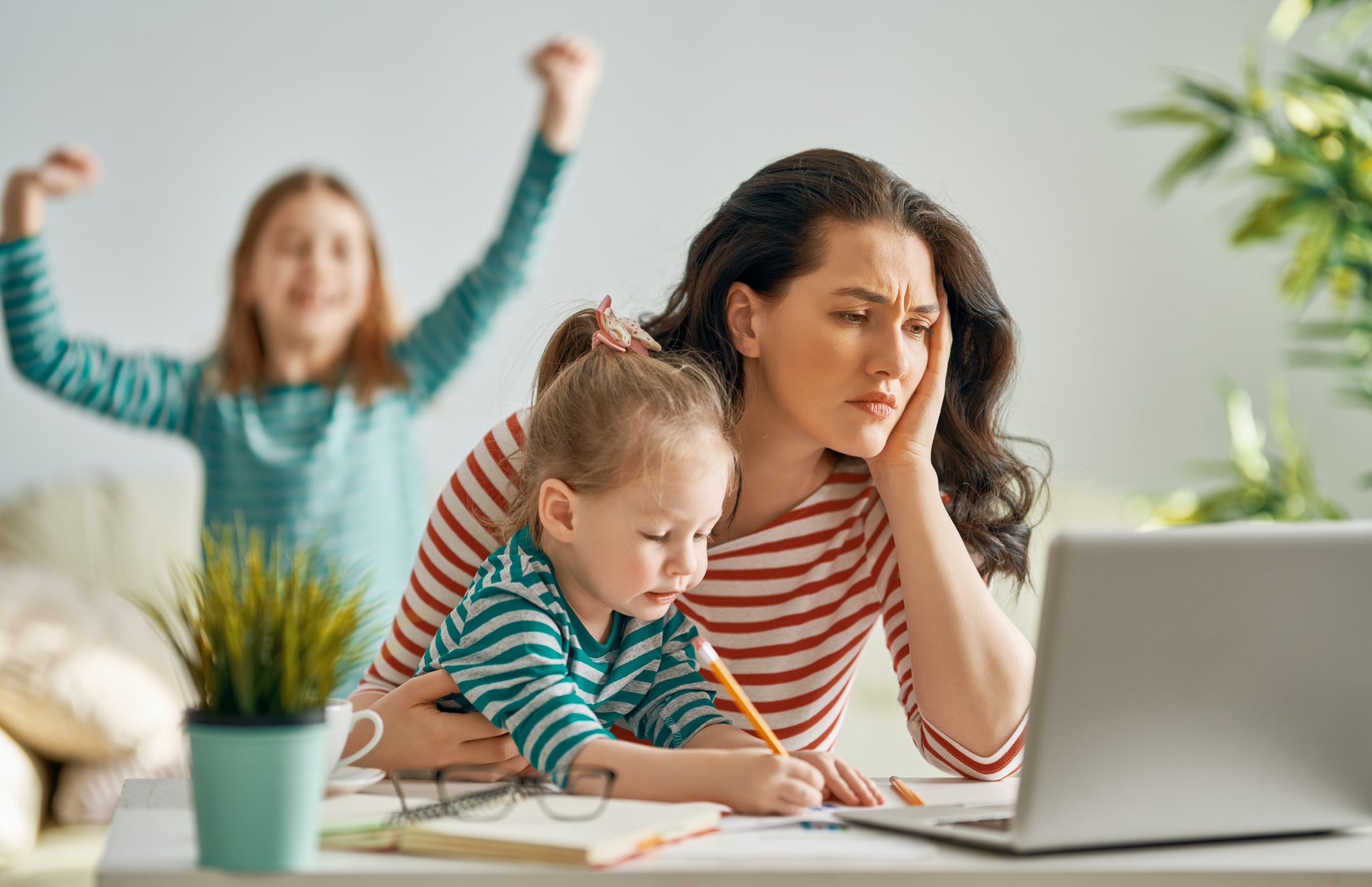 stressed mom trying to work with baby